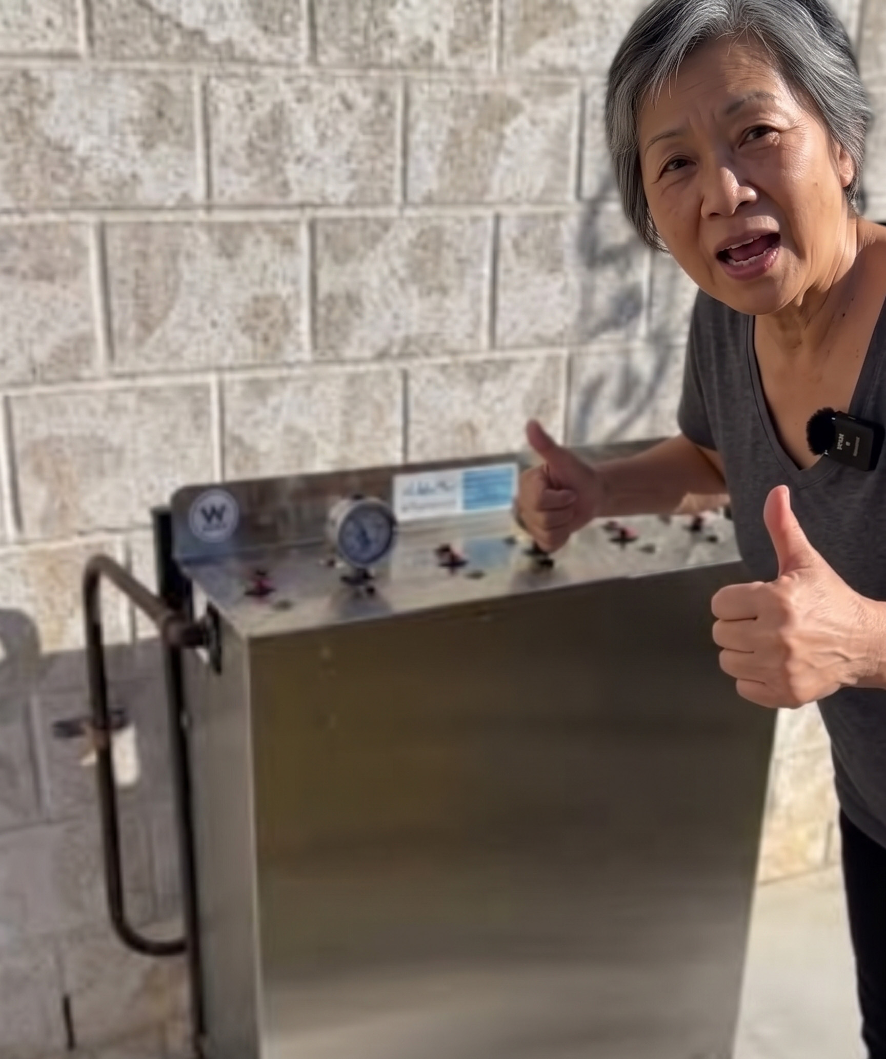 Customer beside a new whole-house water filter installed in the Eastern Suburbs