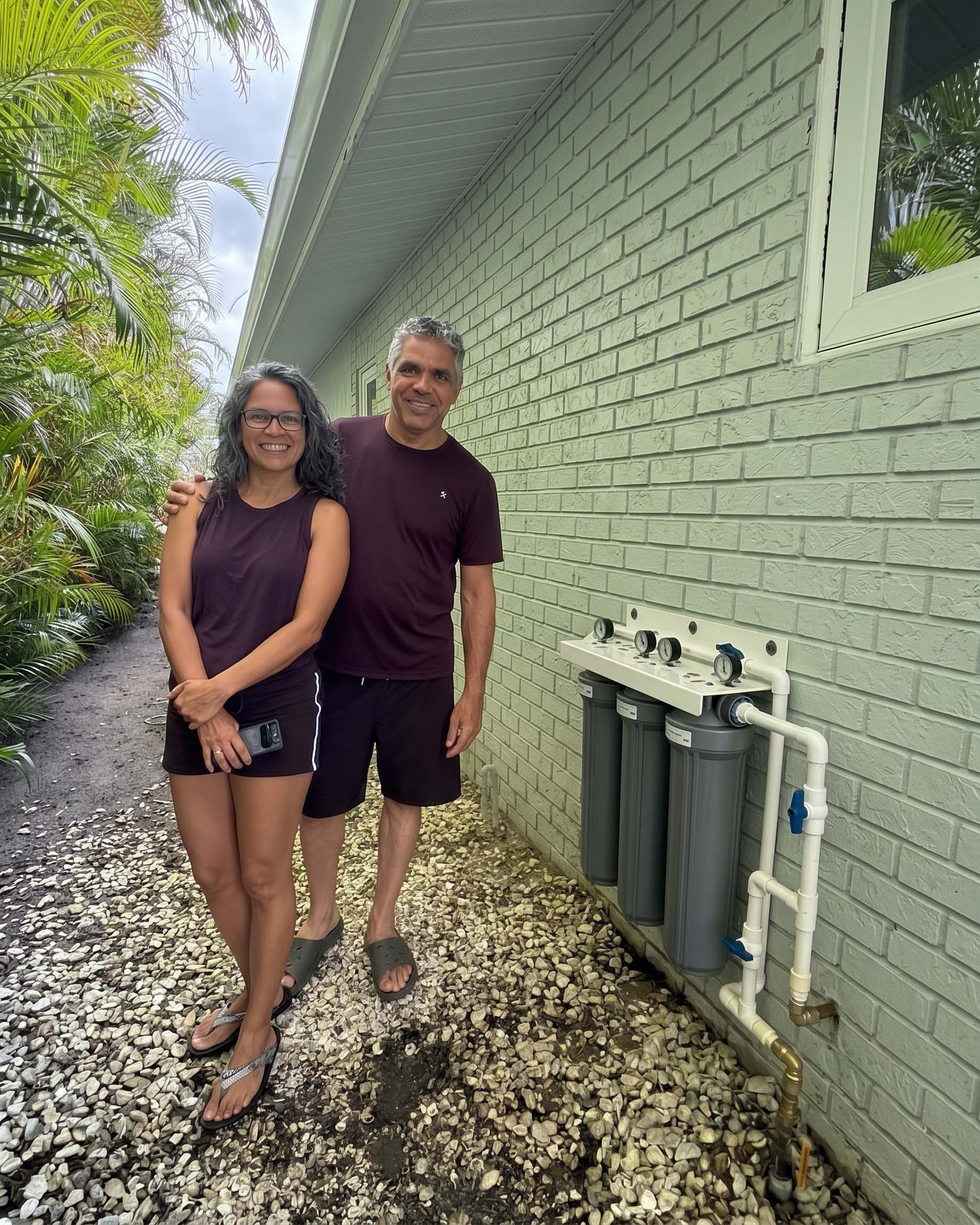 Customers beside a wall-mounted triple filter system installed in the Sutherland Shire